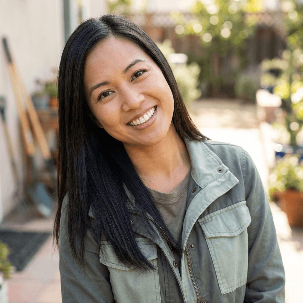 Emily Chen inside her home, petting her dog while reading a training book